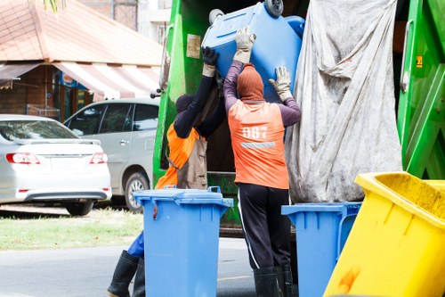 Worker using trolley to move bulky office furniture safely